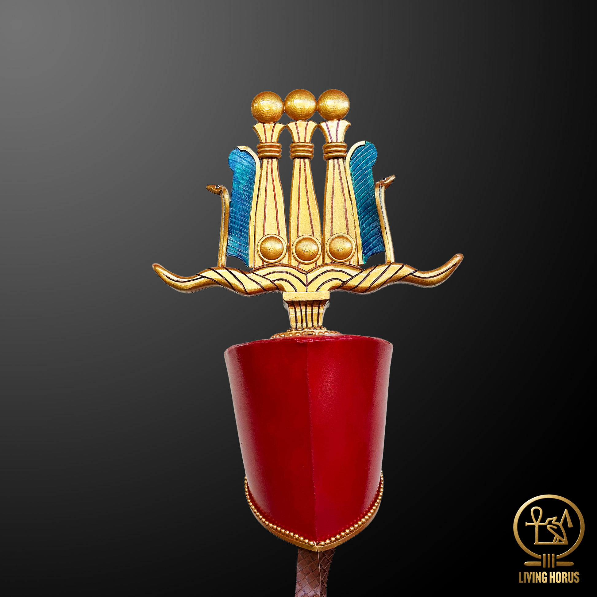 Decorative object with gold, blue, and red colors on a dark background