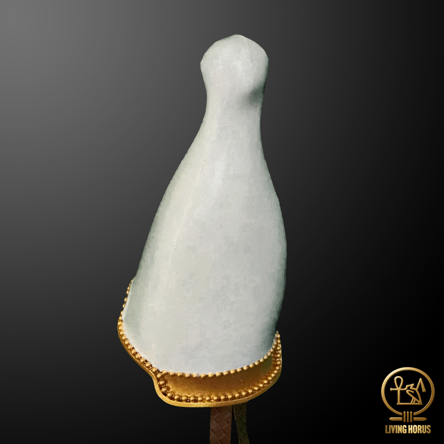 White marble sculpture with gold base on a dark background, featuring the Living Horus logo.