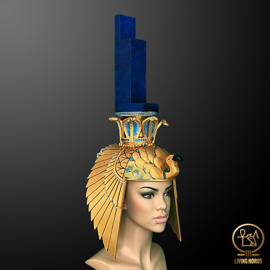 Mannequin head wearing an Egyptian-style headdress with blue and gold elements on a dark background.